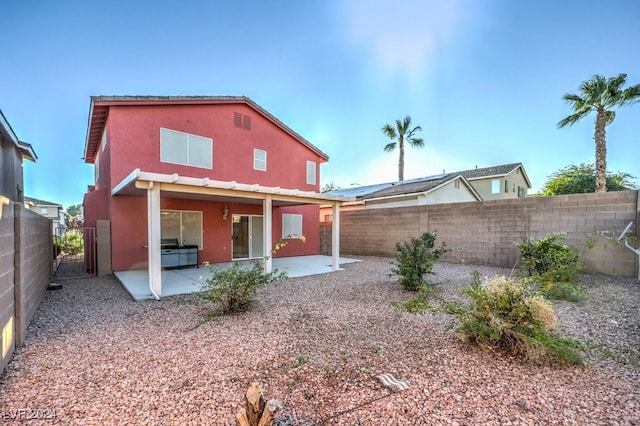 back of property with a patio