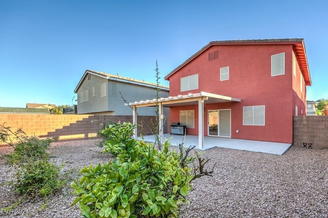 back of property with a patio