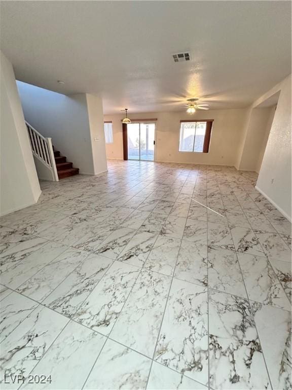 unfurnished living room featuring ceiling fan