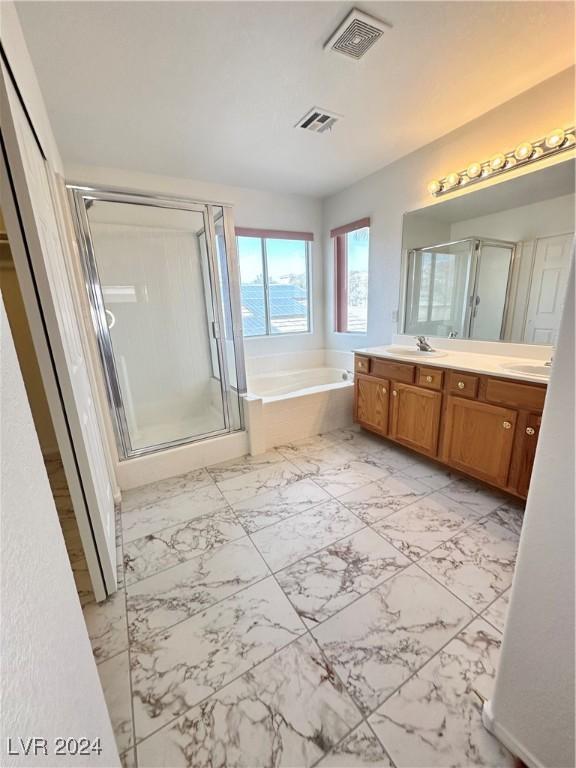 bathroom featuring vanity and shower with separate bathtub