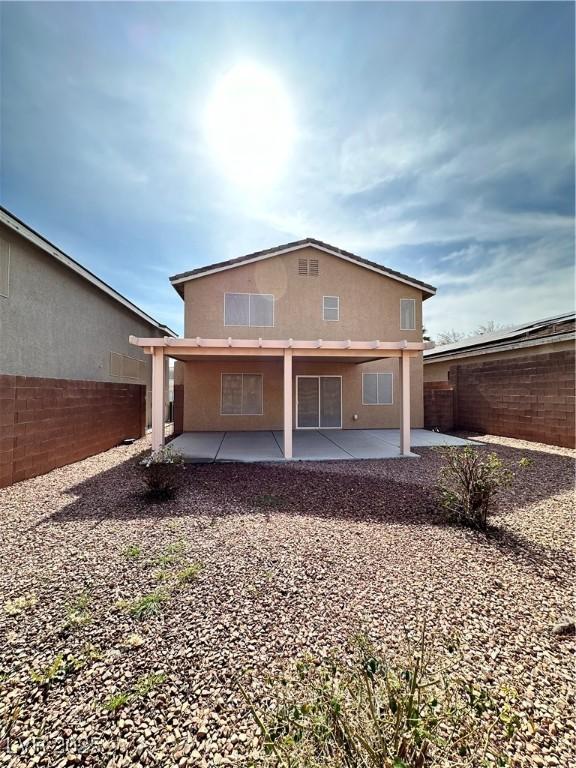 back of property with a patio