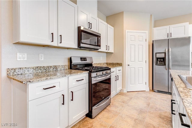 kitchen featuring white cabinetry, sink, light stone countertops, and stainless steel appliances