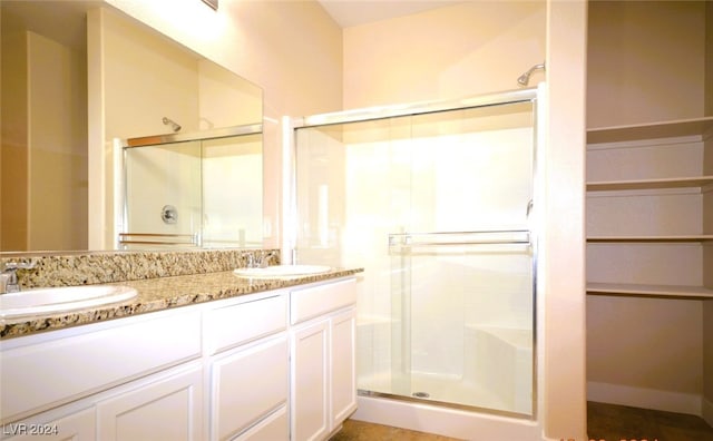 bathroom featuring vanity and an enclosed shower