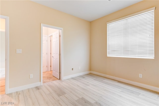 spare room with light hardwood / wood-style flooring and plenty of natural light