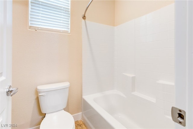 bathroom with toilet and bathtub / shower combination