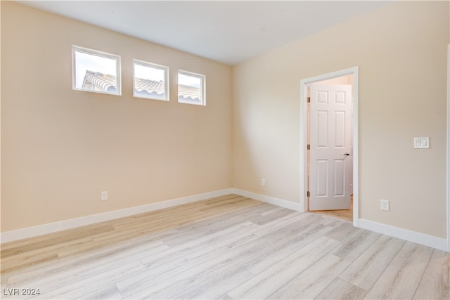 spare room with light hardwood / wood-style flooring