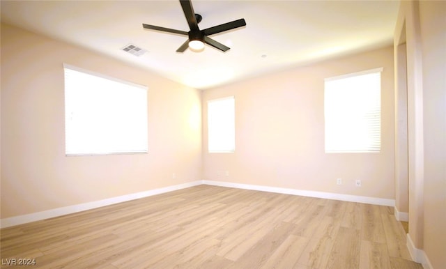 unfurnished room with ceiling fan, plenty of natural light, and light wood-type flooring