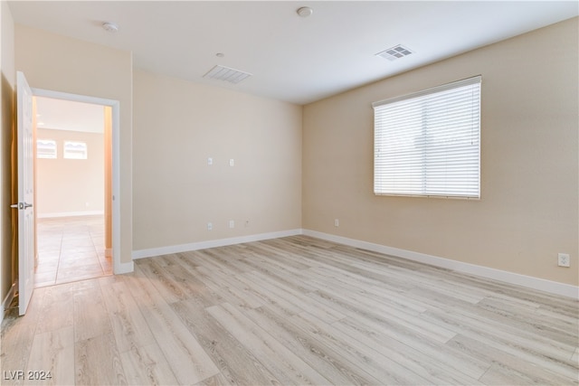 spare room with light hardwood / wood-style floors