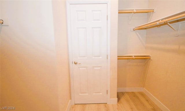 walk in closet featuring light hardwood / wood-style floors