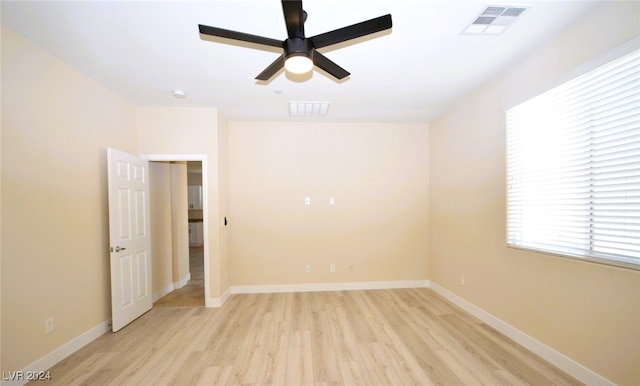 empty room featuring ceiling fan and light hardwood / wood-style flooring