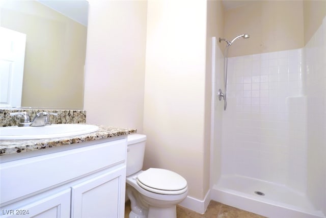 bathroom featuring walk in shower, tile patterned flooring, vanity, and toilet