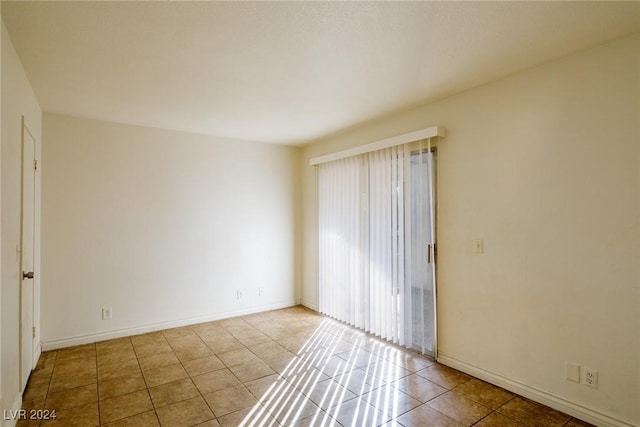 spare room featuring light tile patterned flooring