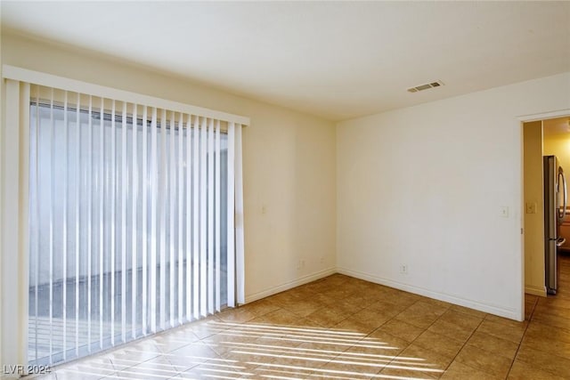 spare room with tile patterned floors