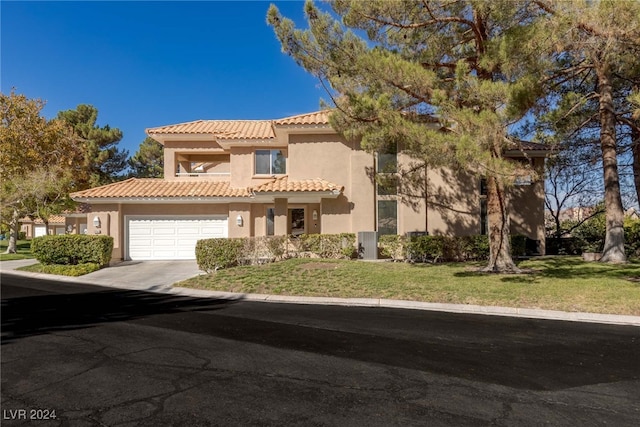 mediterranean / spanish-style house featuring a front lawn