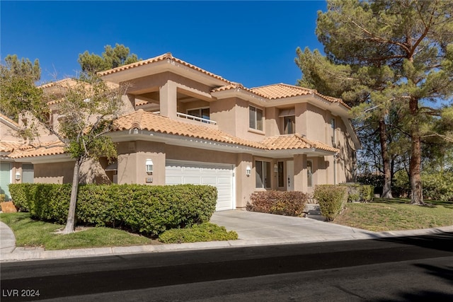 mediterranean / spanish house featuring a garage