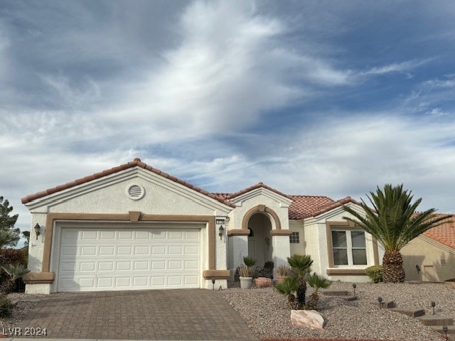 mediterranean / spanish house featuring a garage