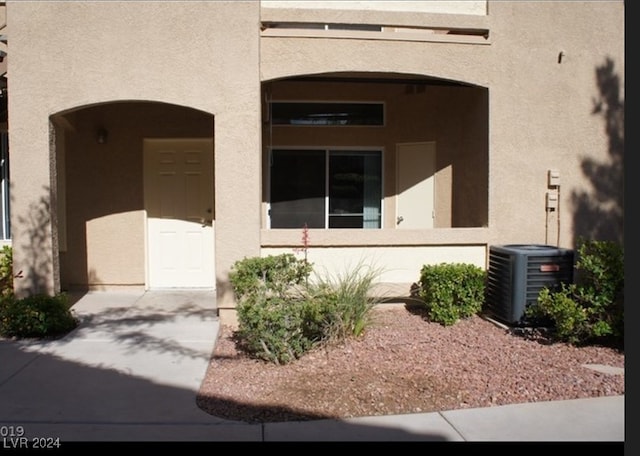 doorway to property featuring central air condition unit