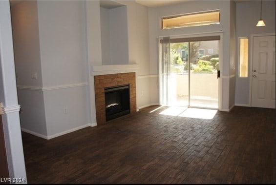 unfurnished living room featuring dark hardwood / wood-style floors