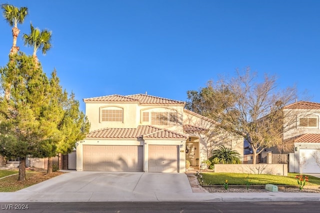 mediterranean / spanish-style house with a front yard and a garage