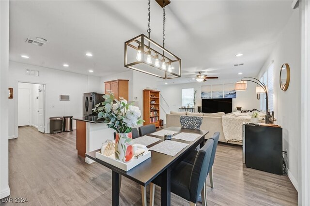 dining space featuring ceiling fan and light hardwood / wood-style floors