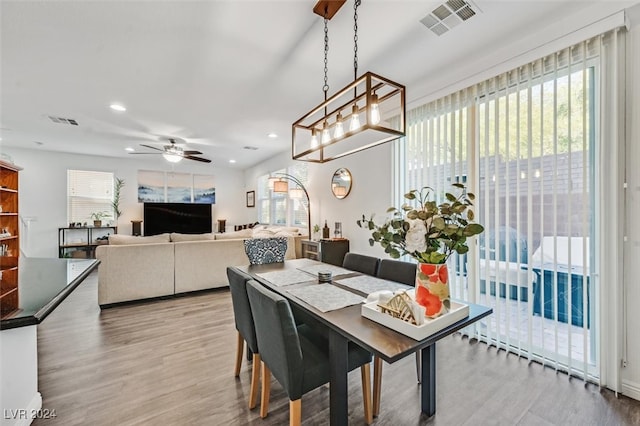 dining area with hardwood / wood-style flooring and ceiling fan