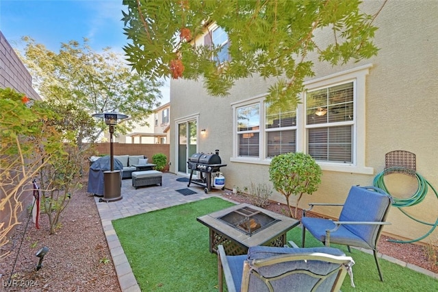 view of yard featuring an outdoor living space with a fire pit and a patio area