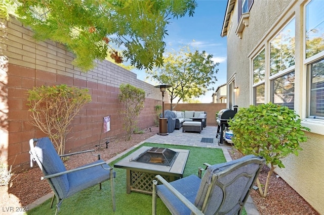 view of patio featuring a grill and an outdoor living space with a fire pit