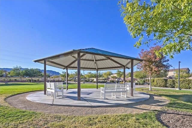 view of property's community with a lawn and a gazebo