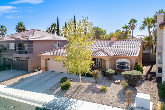 mediterranean / spanish-style home with a garage