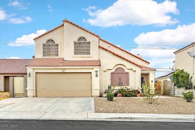 mediterranean / spanish-style home with a garage