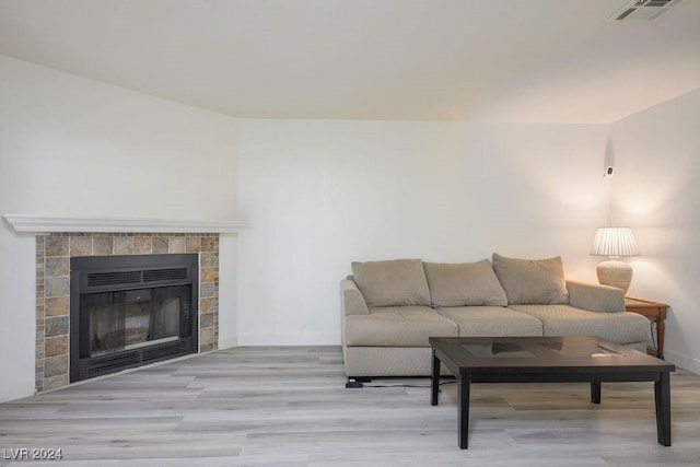 567 Kristin Ln, Henderson, NV 89011 - living room featuring wood finished floors, baseboards, and a tiled fireplace