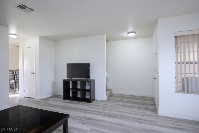567 Kristin Ln, Henderson, NV 89011 - unfurnished living room featuring wood finished floors, baseboards, and stairs