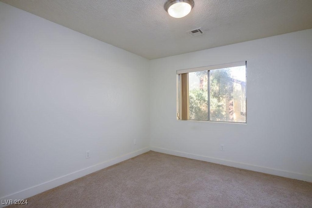 567 Kristin Ln, Henderson, NV 89011 - unfurnished room with light carpet, baseboards, and a textured ceiling