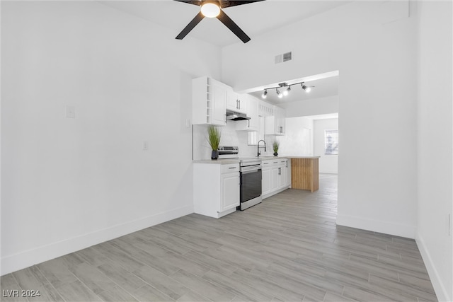 kitchen with white cabinets, sink, light wood-type flooring, and electric stove