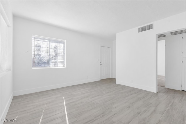 unfurnished room featuring light hardwood / wood-style floors