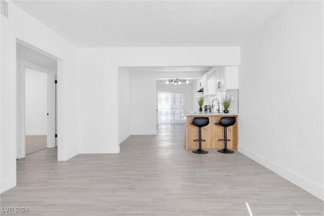 hallway featuring light hardwood / wood-style floors and sink