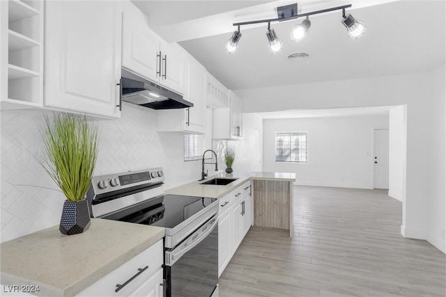 kitchen with light stone countertops, stainless steel electric range, white cabinetry, and sink