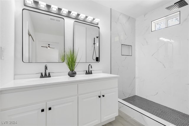 bathroom featuring vanity and tiled shower