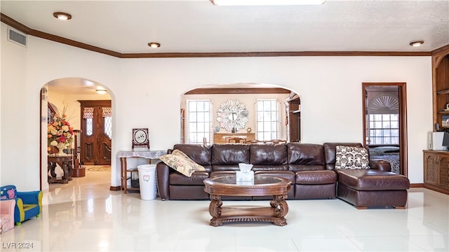 living room featuring a textured ceiling and crown molding