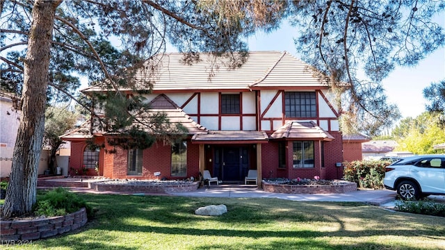 tudor home with a front yard