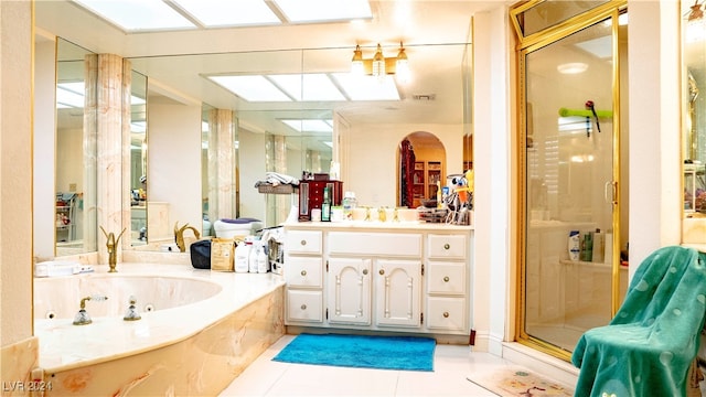 bathroom featuring vanity, tile patterned floors, and plus walk in shower