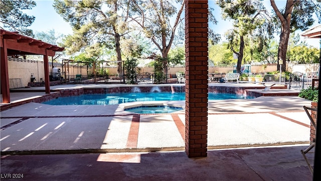 view of pool with a patio and an in ground hot tub