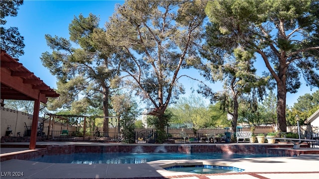 view of pool with an in ground hot tub