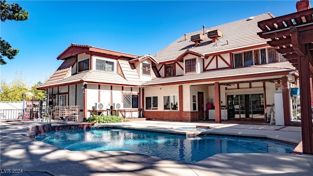 back of house with ceiling fan, a patio, and a fenced in pool