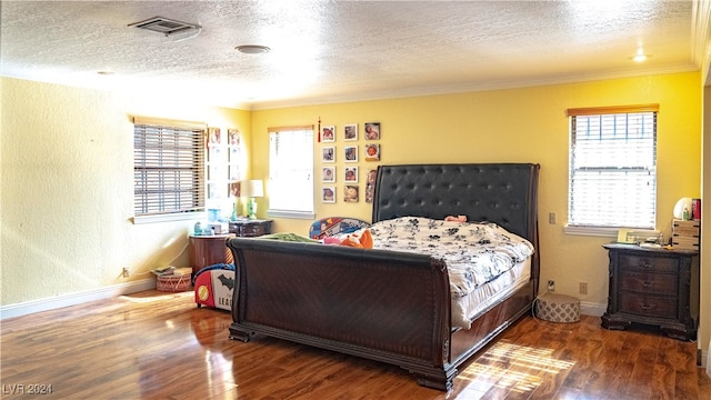 bedroom featuring a textured ceiling, dark hardwood / wood-style flooring, and crown molding