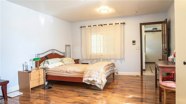 bedroom with dark hardwood / wood-style flooring