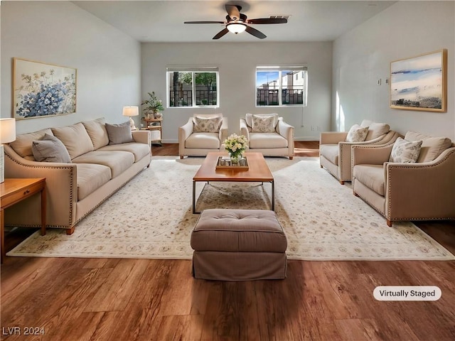 living area featuring ceiling fan, wood finished floors, and baseboards