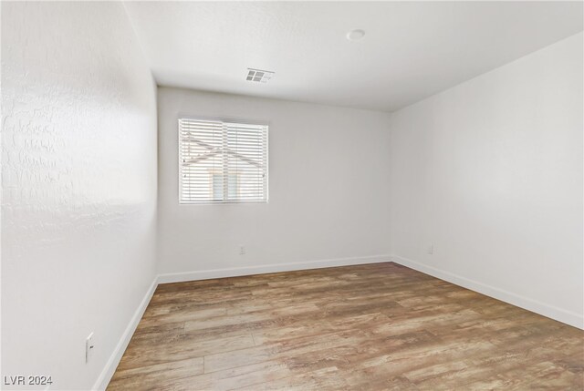 unfurnished room with hardwood / wood-style floors