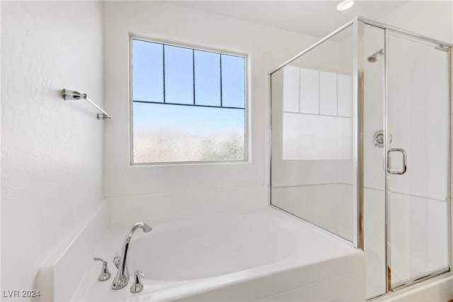 bathroom with a healthy amount of sunlight and separate shower and tub