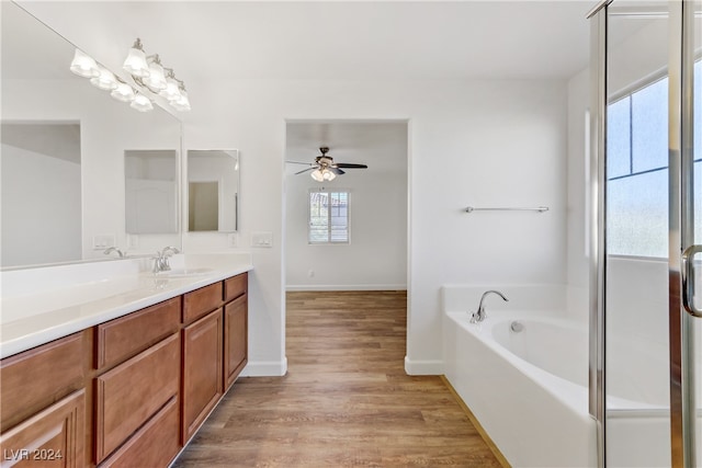 bathroom featuring vanity, wood-type flooring, ceiling fan, and plenty of natural light